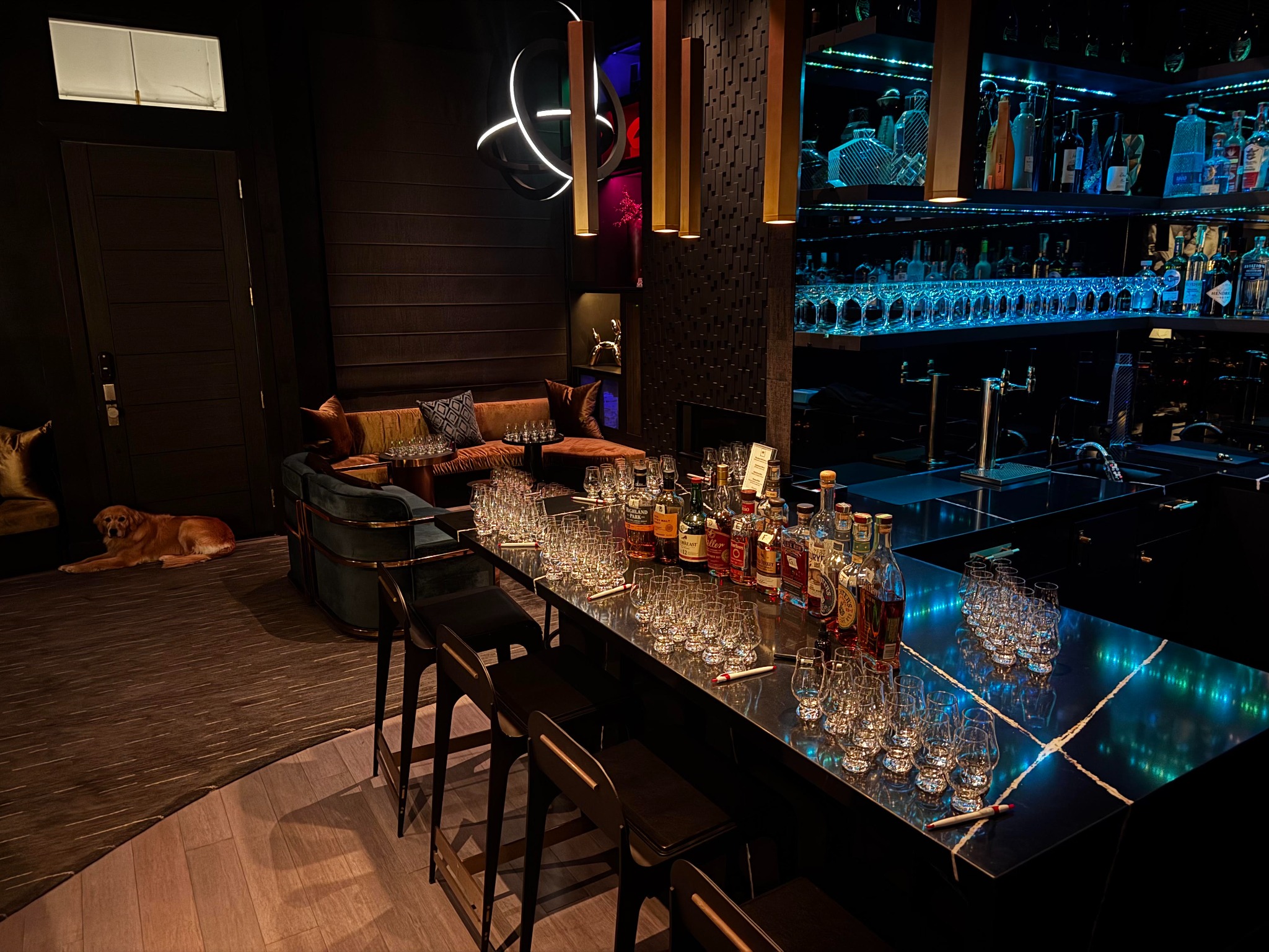An intimate whiskey tasting room prepared with glasses and bottles